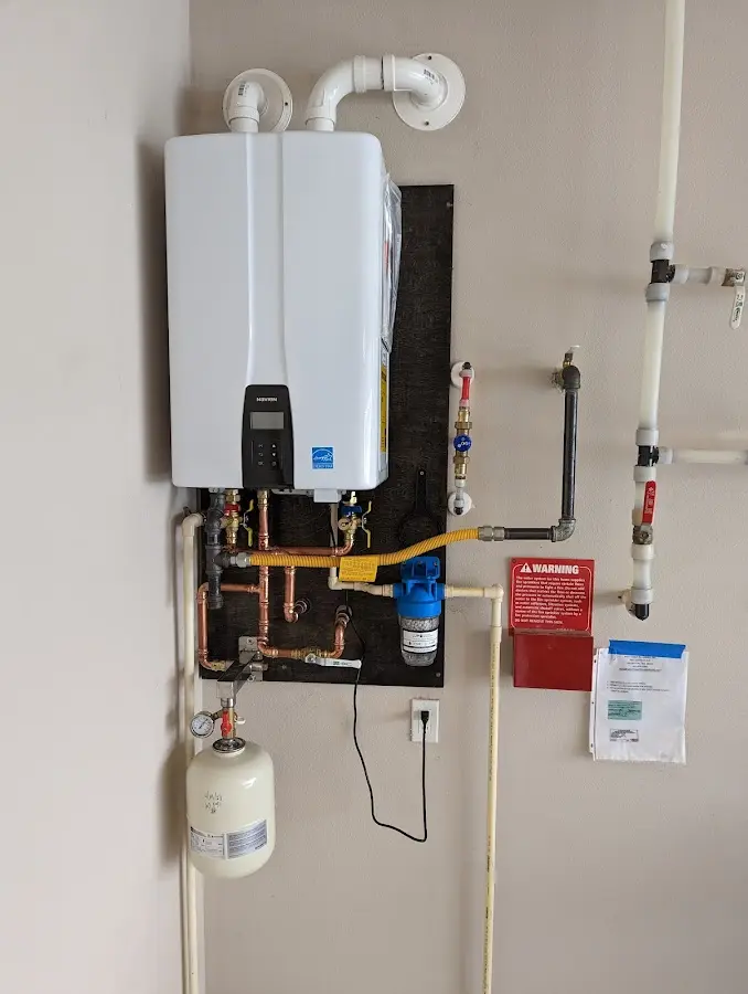 Professional plumber installing copper piping in a Calera home